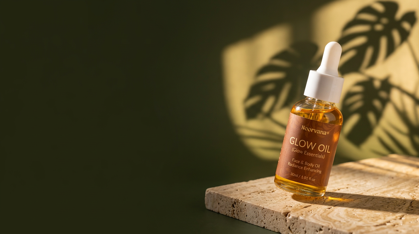 Noorvana glow oil bottle on travertine against a deep green background